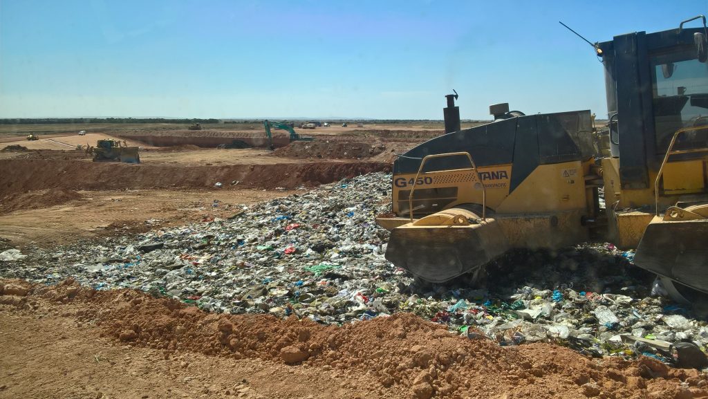 Landfill Site with a Roller going over the rubbish